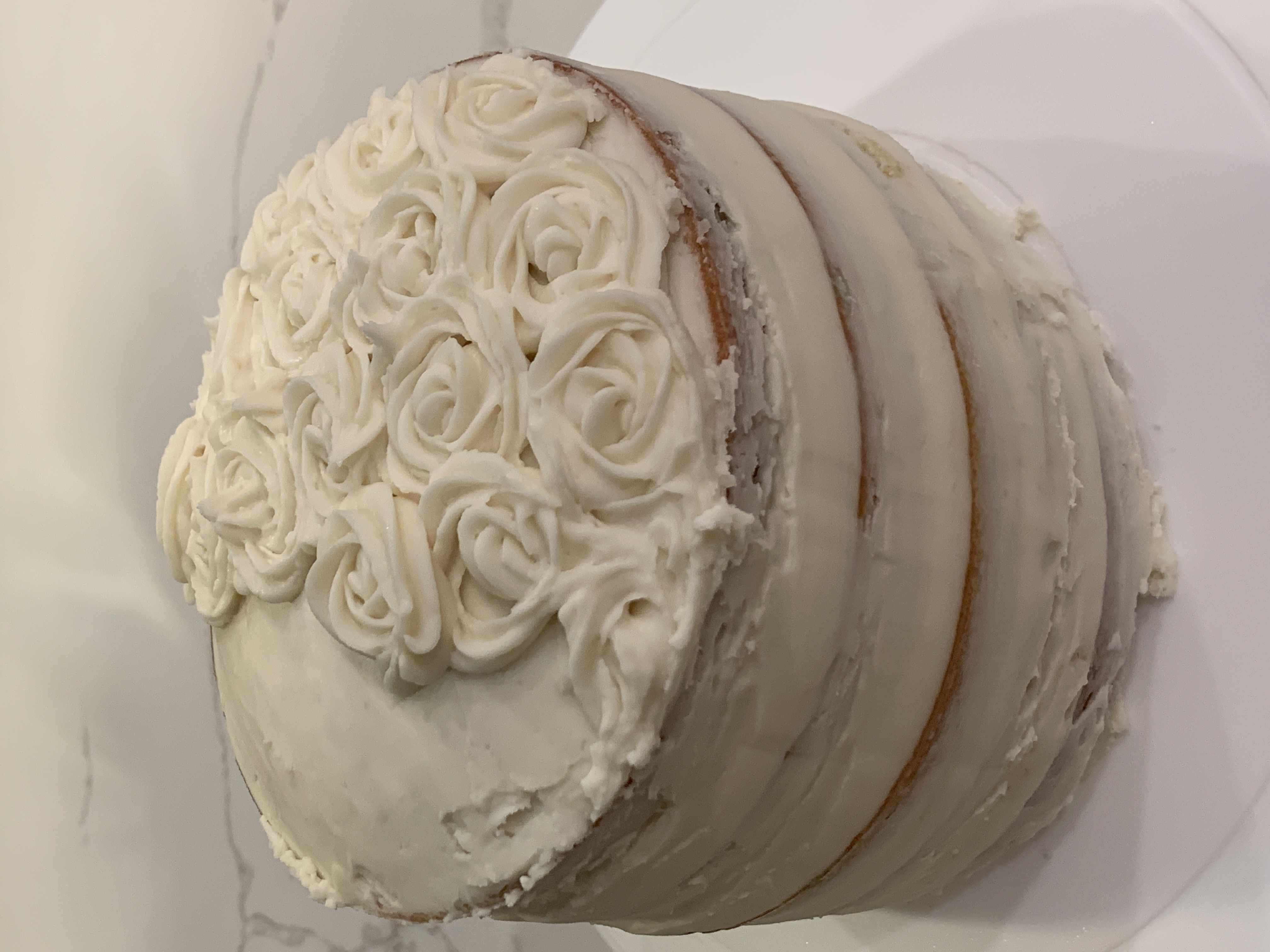 Vanilla cake with white frosting flowers