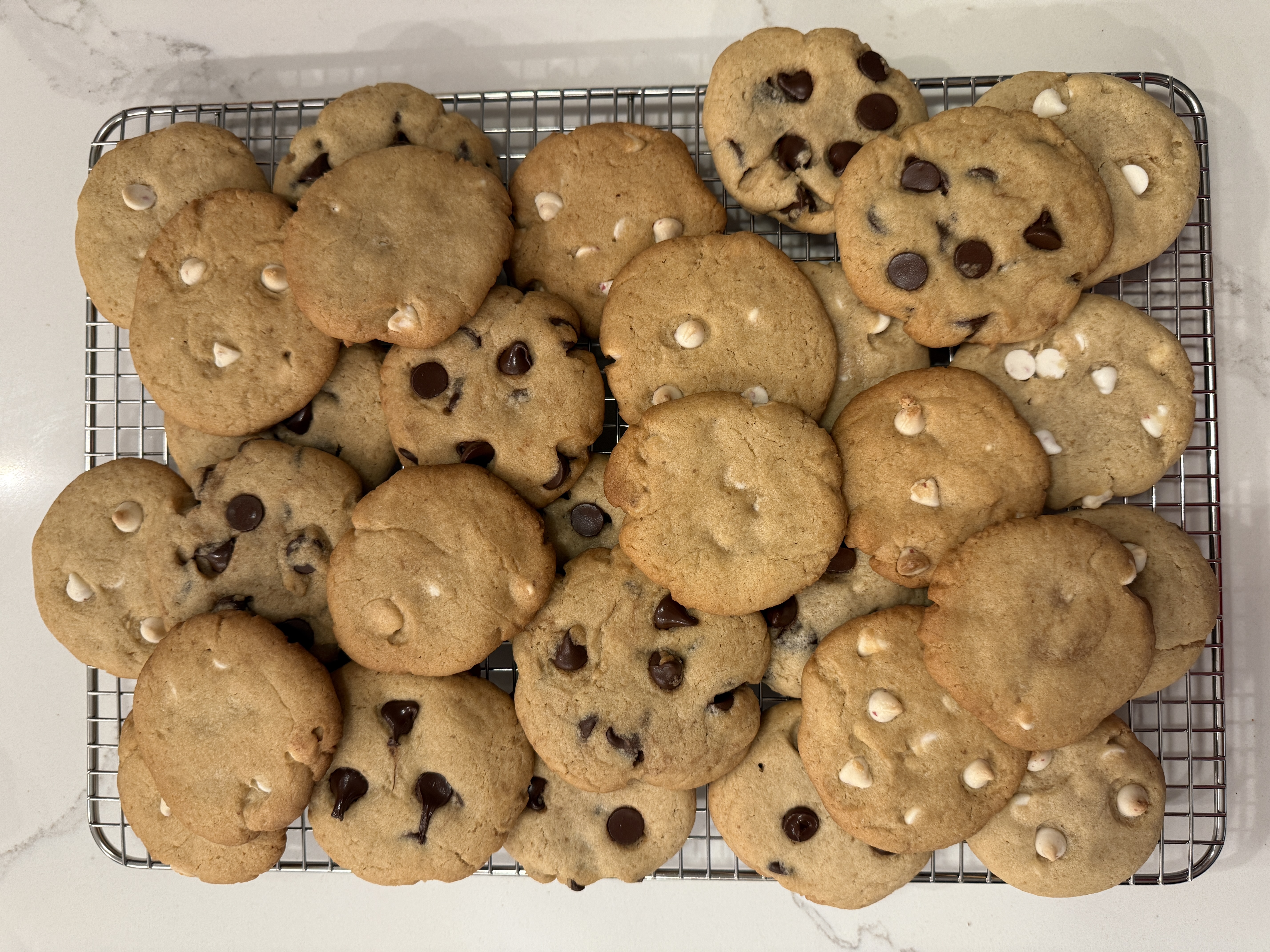 Chocolate chip and peppermint chocolate chip cookies on a cooling rack