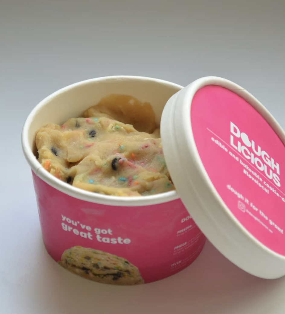 A container of Doughlicious edible cookie dough with sprinkles.