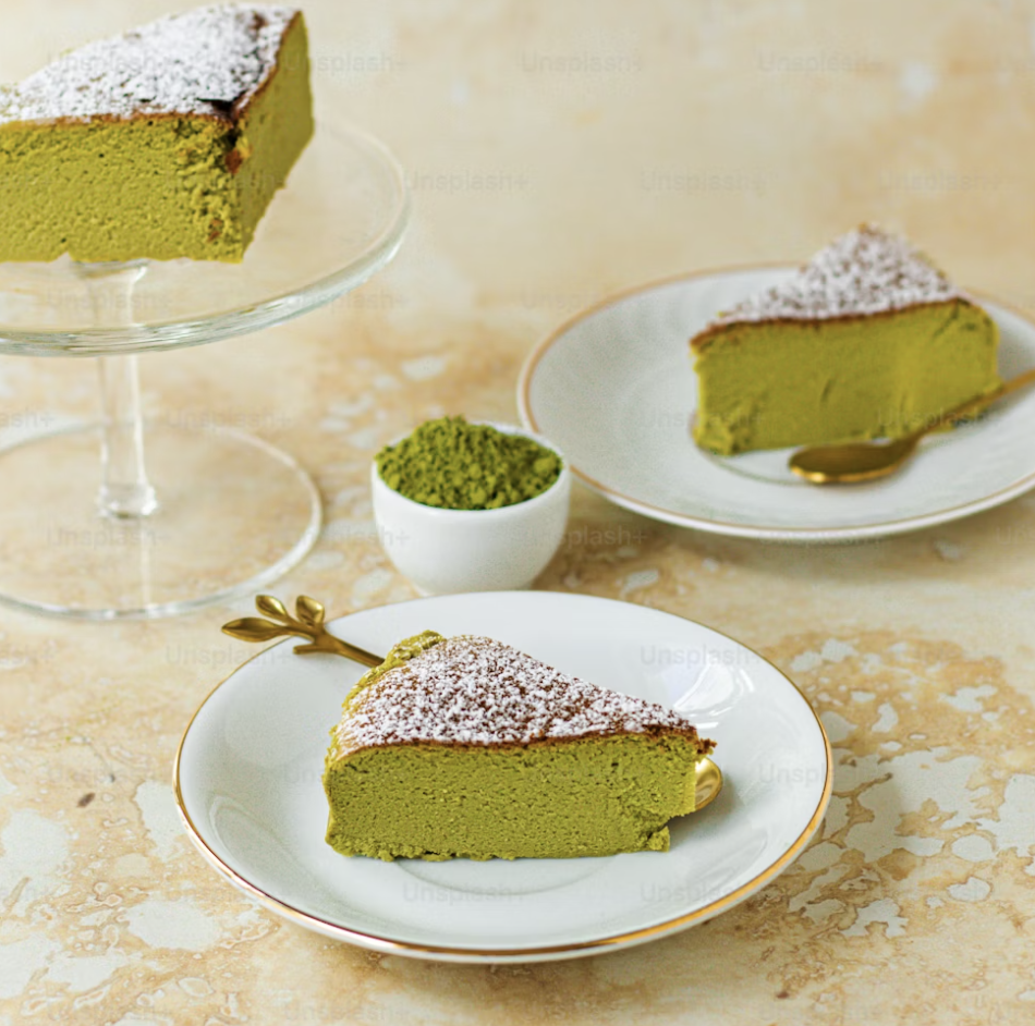 Slices of green, matcha cheesecake on plates.